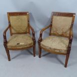A pair of early 19th century mahogany and original silk-upholstered Empire style open arm chairs (