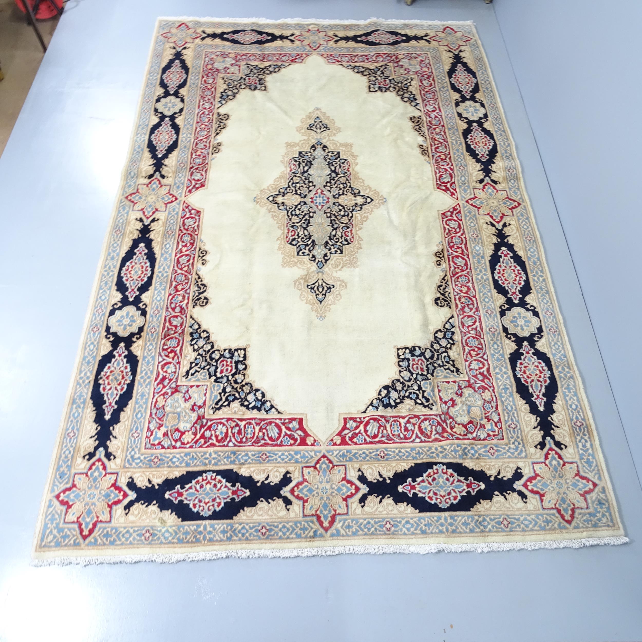 A cream-ground Kirman carpet. 285x180cm.