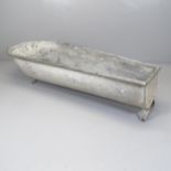 A galvanised metal trough. 173x28x67cm
