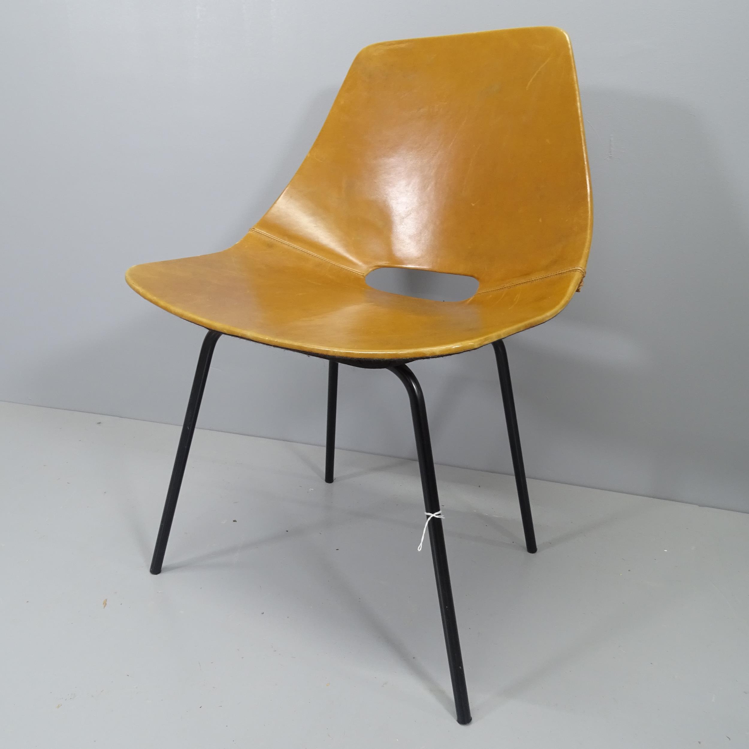 Pierre Guariche, France, a Tonneau chair, the leather clad shell seat on black tubular steel legs,