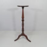 A reproduction mahogany jardiniere stand on tripod base. Height 100cm