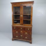 A two-section Queen Anne walnut bookcase on chest, having three short and two long drawers, raised