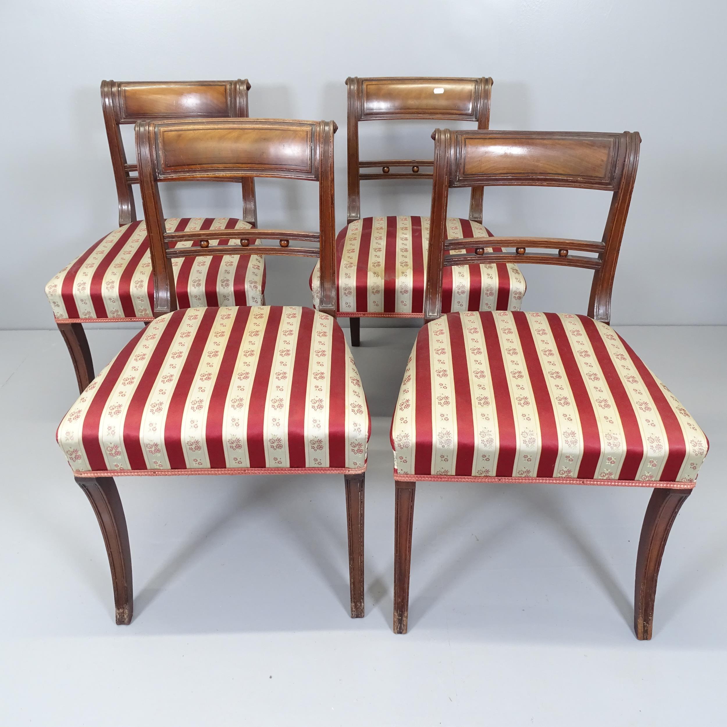 A set of four Georgian mahogany dining chairs.