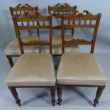 A set of four late Victorian walnut and upholstered dining chairs.