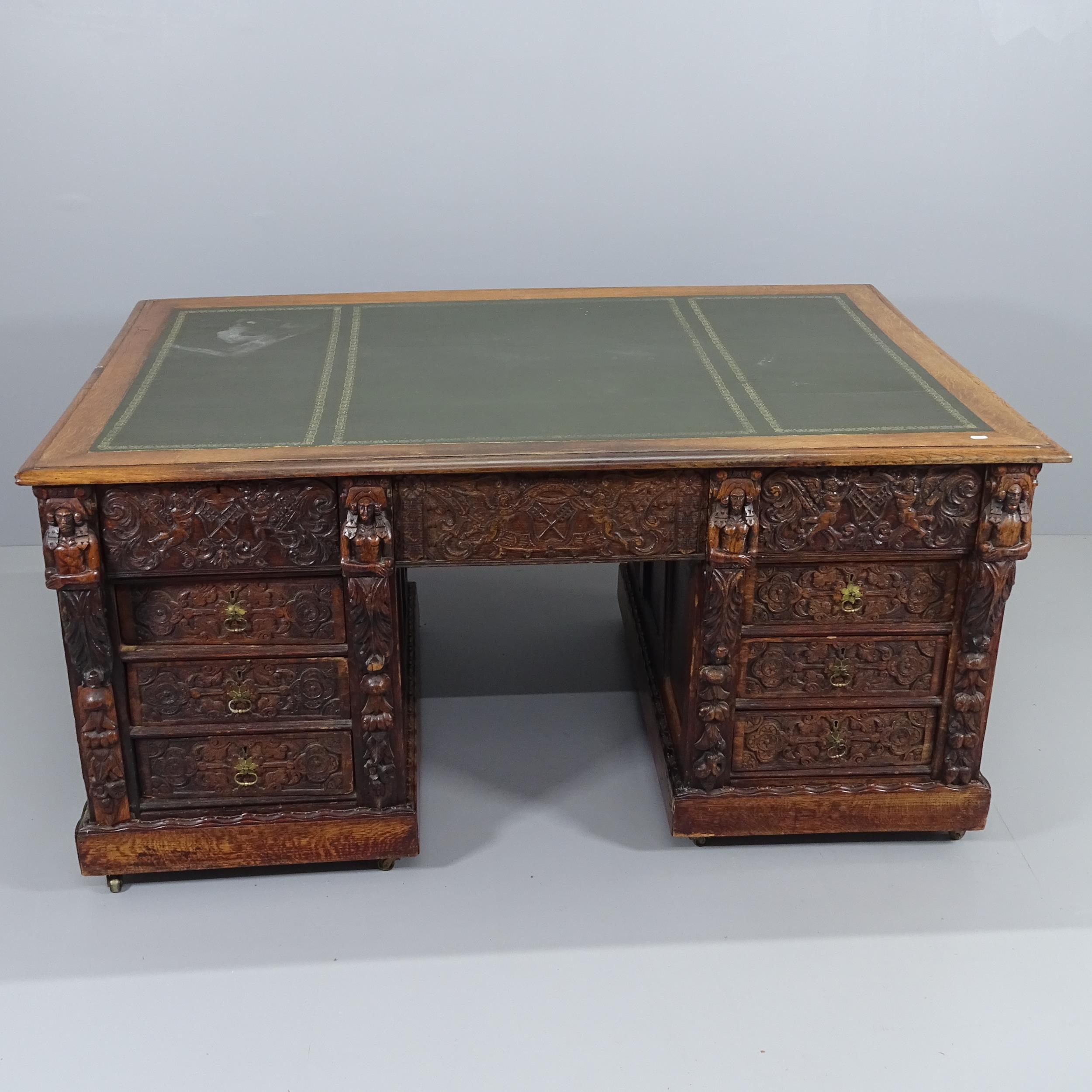 A Victorian carved oak partner's twin pedestal writing desk, woith tooled and embossed green leather