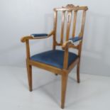 An Arts and Crafts Gothic oak and upholstered open arm chair. (Originally from Croydon baptist