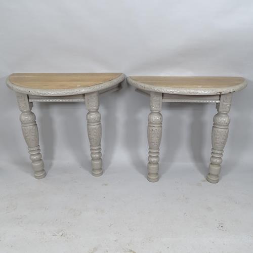 A pair of carved and painted oak bow end console tables on turned legs. 101x86x54cm