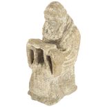 A Ecclesiastic stone carving of a monk reading a Bible, height 14cm Several chips to base, otherwise