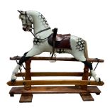An early 20th Century dappled grey Rocking Horse in the manner of F.H.Ayres, London, with studded
