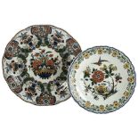 2 Delft wall-hung plates with floral decoration, largest diameter 37.5cm Largest plate has small