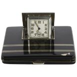 An Art Deco compact / travel clock, in black lacquer and silver plate detail, 7.5cm sq Some