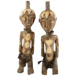 A pair of West African carved wood figures, tallest 44cm Natural faults in the wood, no repairs
