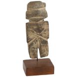 A pre-Columbian hardstone carved figure on mounted wood and metal stand, height of figure 13cm