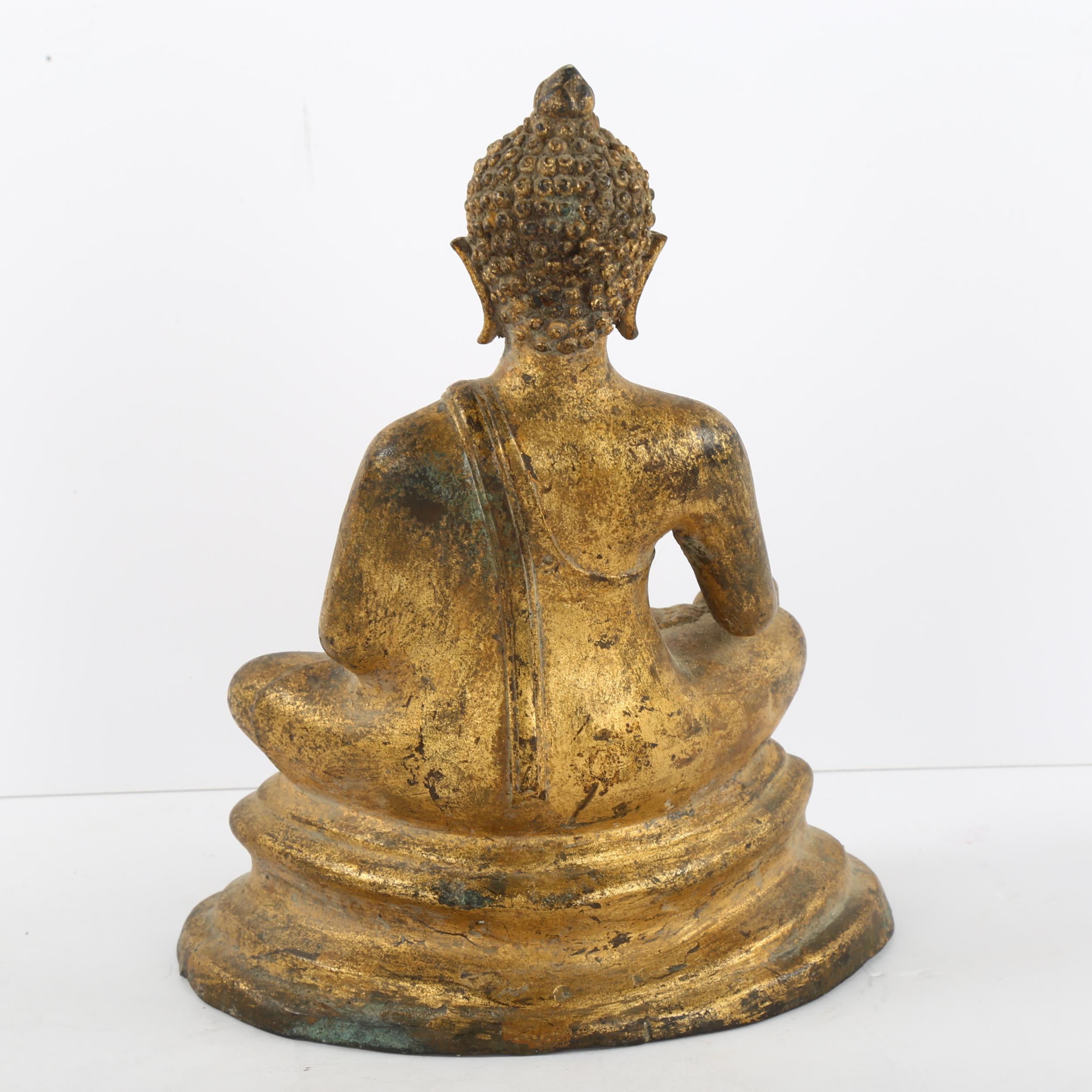 A gilded cast-metal figure of a Buddha, height 23cm Filled and weighted to interior, numbers have - Image 2 of 3