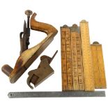 A bronze-based 19th century smoothing plane, a bronze bull nosed plane and 5 folding rules, no
