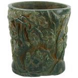 A Chinese green hardstone relief carved brush pot, character marks to back and base, height 15.5cm