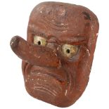 An Antique Japanese wood carved Noh wall mask of Tengu with articulated nose, length 19cm Chips to