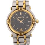 GUCCI - a lady's gold plated stainless steel 9000L quartz bracelet watch, speckled black dial with
