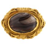 A Victorian Etruscan style banded agate brooch, unmarked yellow metal settings with wirework