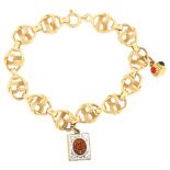 An Italian 18ct gold fancy link charm bracelet, with enamel Koran charm, bracelet length 20cm, 21.3g