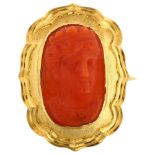 A Victorian coral cameo brooch, unmarked yellow metal frame with relief carved coral panel depicting