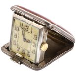 An Art Deco sterling silver and red enamel travelling bedside timepiece, square silvered dial with