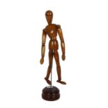 An artist's lay figure of jointed form, on turned wood base, H36cm