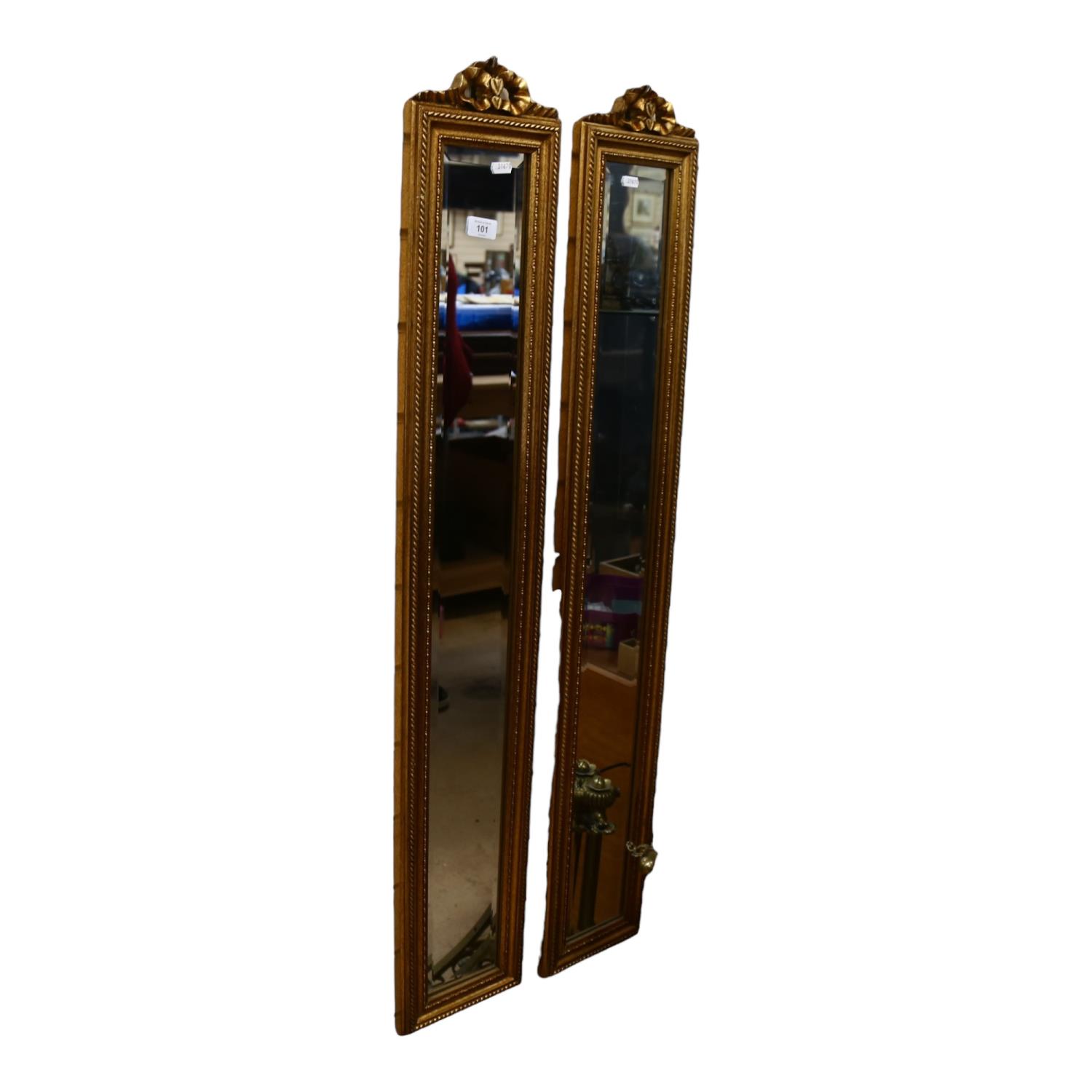 A pair of modern rectangular gilt-framed bevel-edge mirrors of narrow form, with ribbon mount,