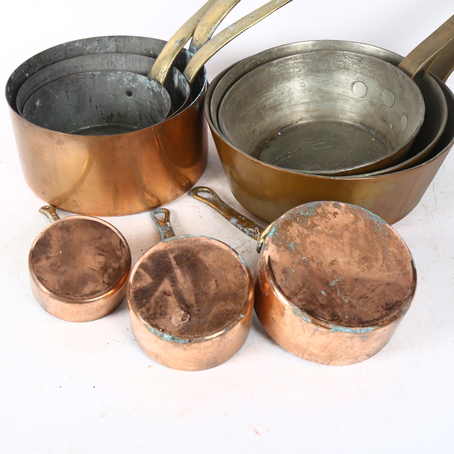 A graduated set of 3 copper pans with brass handles, largest 20cm diameter, and a set of 6 copper - Image 2 of 2