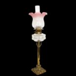 A Victorian embossed brass oil lamp, with glass font, chimney and etched glass shade, H74cm