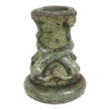 An Antique carved and polished stone 2-section pedestal, with stylised serpent decoration, on a