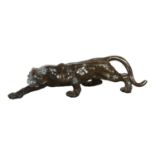 A patinated resin bronze study of a prowling panther, on a stoneware stand, stand L63cm