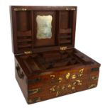 An Anglo-Indian brass-bound teak travelling writing box, the rising lid revealing a fitted interior,