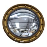 A gilt-framed circular convex wall mirror, diameter 54cm (frame damaged)