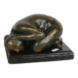 A bronzed ceramic sculpture, depicting a crouching nude, on wooden plinth, L18cm