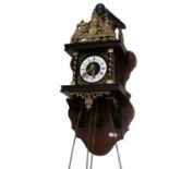 A Continental wall clock with ornate brass mounts, and weights, height approx 50cm