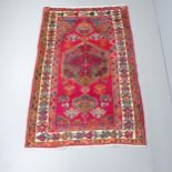 A red-ground Afghan rug. 204x130cm Nice overall condition. Light signs of wear and some edging is