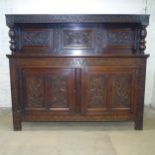 An antique carved oak court cupboard. 182x153x53cm