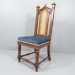 WITHDRAWN - An antique Gothic oak and upholstered Pugin style chair, with cane panelled back.