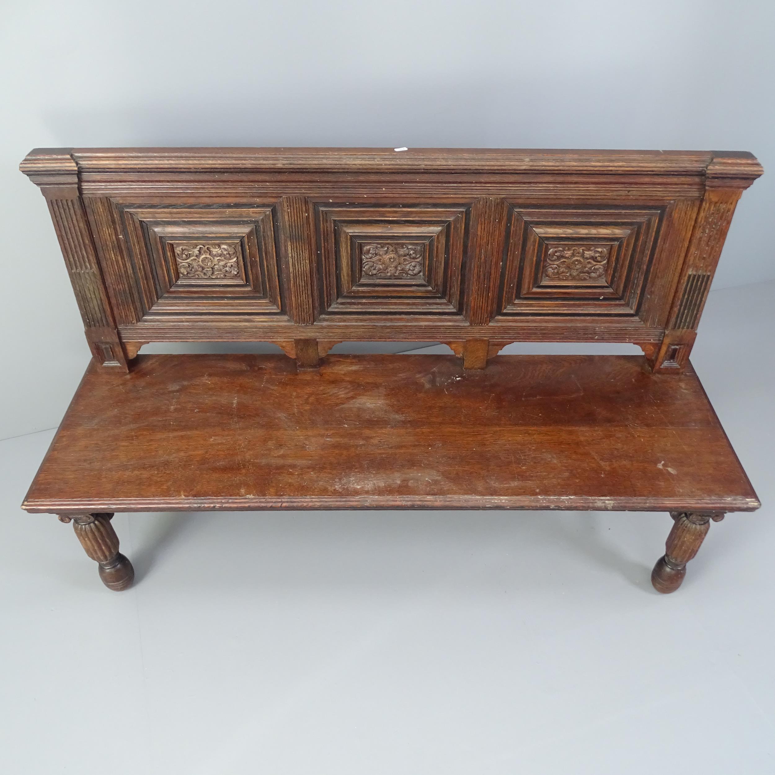 An antique carved and panelled oak hall seat. 145x91x50cm - Image 2 of 2