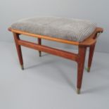 A mid-century Danish design teak and brass stool, the teak frame with brass handles and sabots.