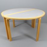 A Danish circular dining table in two demi-lune parts with bent ply legs by Rud Thygesen and