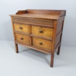 An early 20th century oak sideboard, with raised top, carved secret drawer, and two short and one