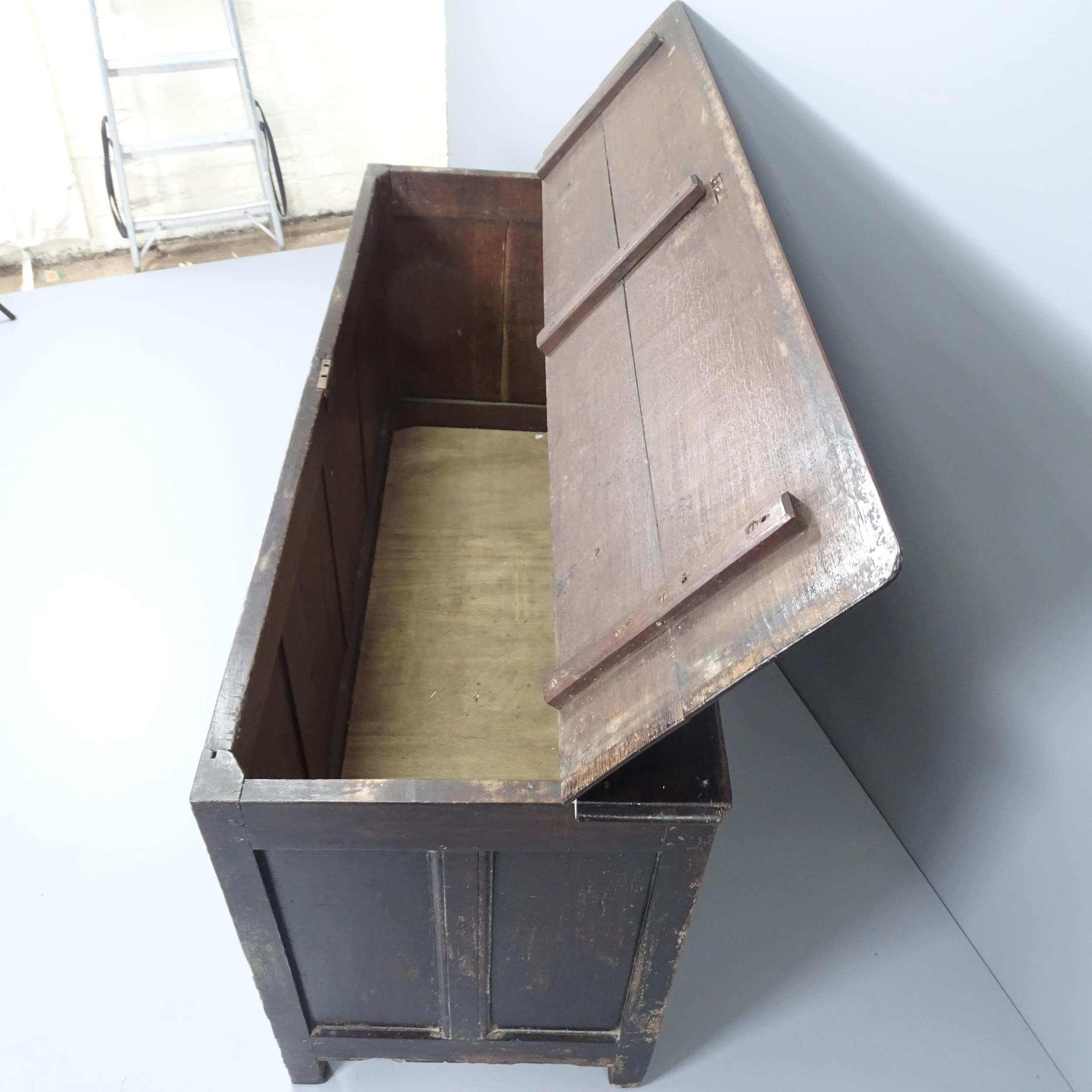 A 19th century panelled oak coffer, with chip carved decoration and raised on stile legs. - Image 2 of 2