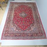 A red ground Tabriz carpet. 315x218cm