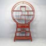 A Chinese red-lacquered hardwood display unit. 106x184x26cm