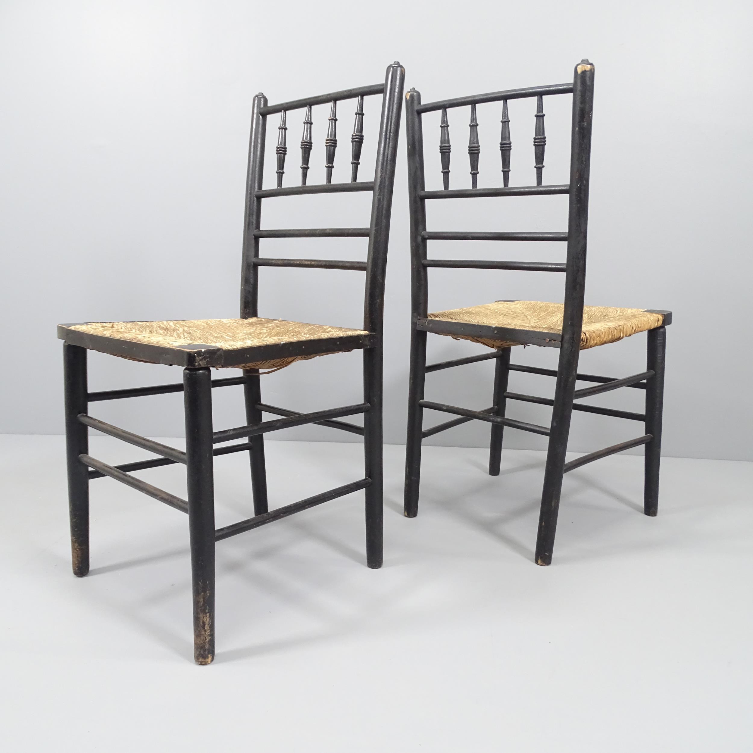 A pair of Morris & Company Arts & Crafts spindle back ebonised Sussex chairs with rush seats. - Image 2 of 2