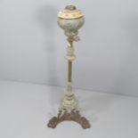 An antique wrought iron oil lamp stand, lacking burner and shade. Height 122cm.