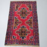 A red ground Baluchi rug, 147x89cm Good condition.