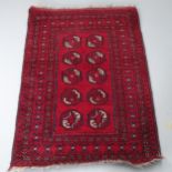 A red-ground Afghan rug, 122x90cm.